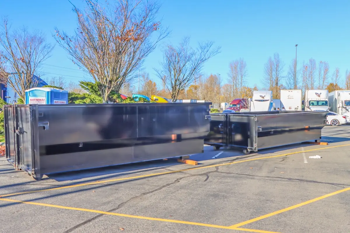 Professional dumpster rental service with roll-off container on residential driveway in Coral Hills